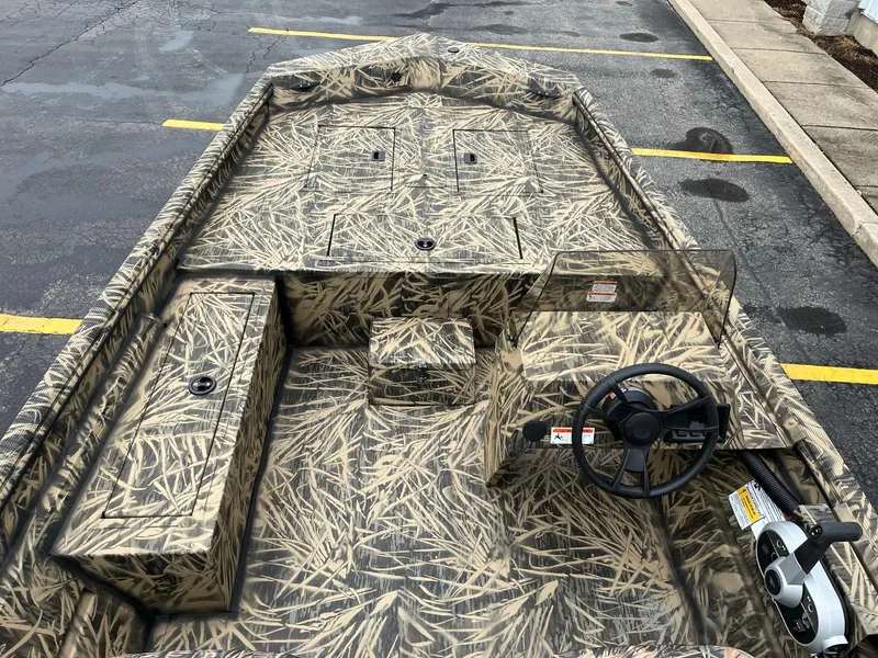 Slide: The Image of 2024 Lowe Roughneck RX1660 SC camo boat interior with steering console. - 5