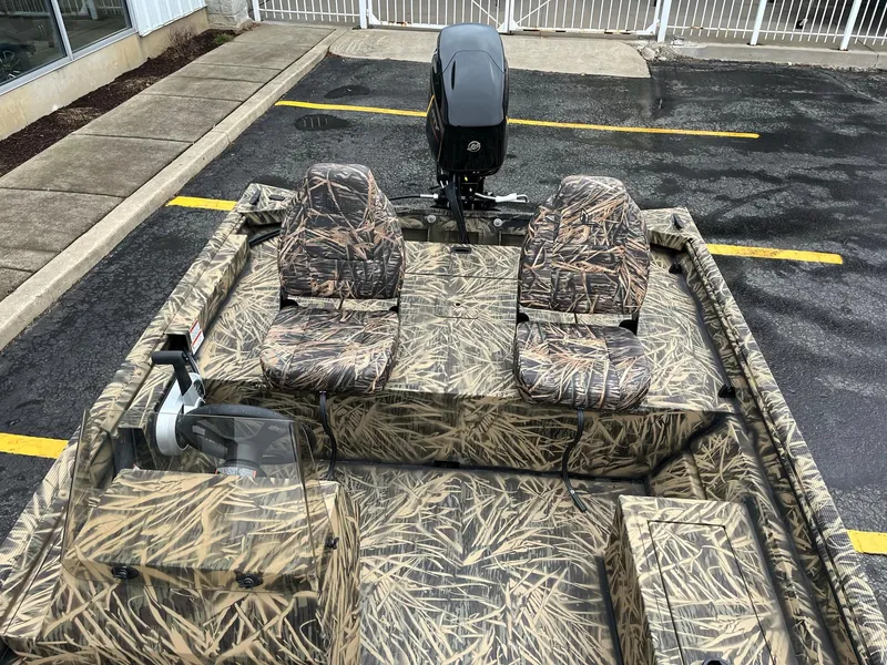 Slide: The Image of 2024 Lowe Roughneck RX1660 SC camo boat with dual seats and outboard motor. - 6