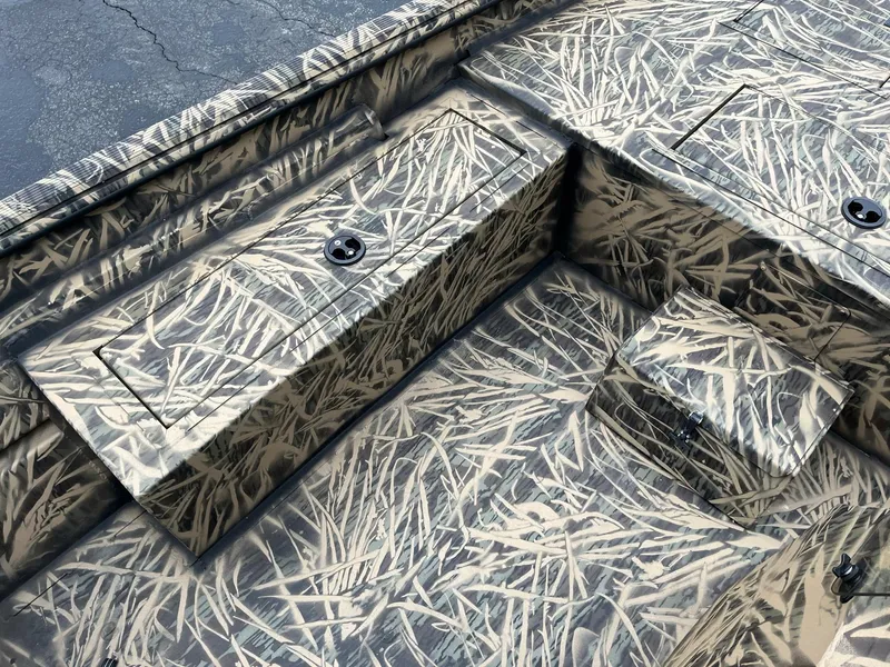 Slide: The Image of 2024 Lowe Roughneck RX1660 SC boat interior with camo pattern. - 9