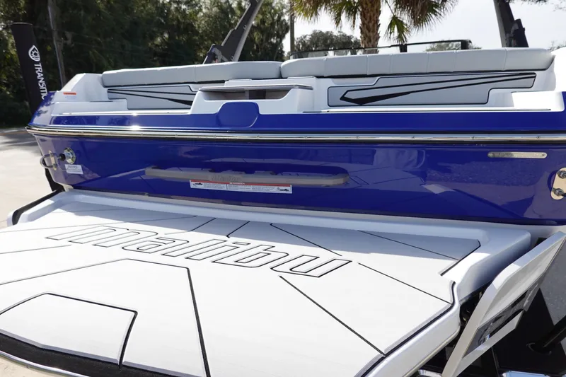 Slide: The Image of 2024 Malibu 21 LX-R boat rear view with swim platform. - 10