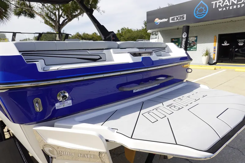 Slide: The Image of 2024 Malibu 21 LX-R boat rear view at dealership. - 11
