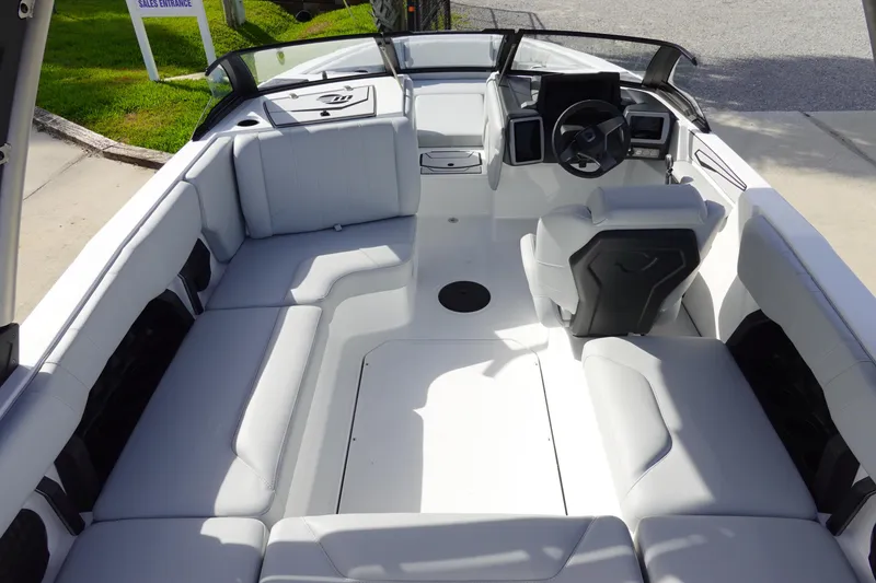 Slide: The Image of 2024 Malibu 21 LX-R boat interior with spacious seating and modern dashboard. - 13