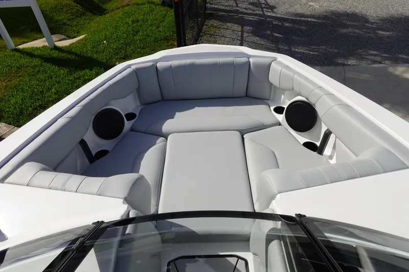 Slide: The Image of 2024 Malibu 21 LX-R boat with spacious cushioned seating and built-in speakers. - 14