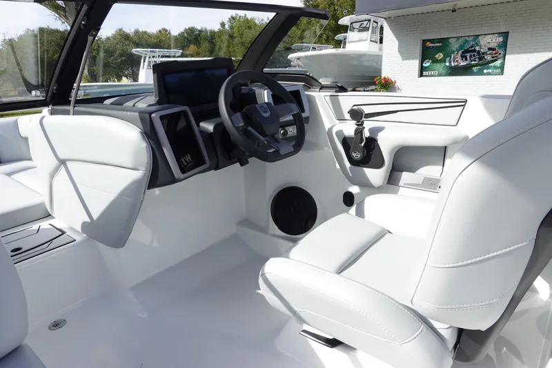 Slide: The Image of 2024 Malibu 21 LX-R boat interior with modern dashboard and steering wheel. - 18