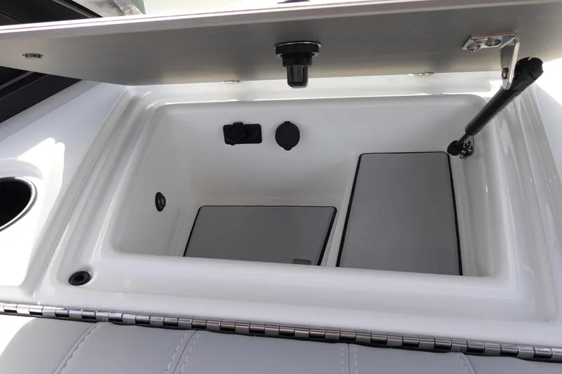 Slide: The Image of 2024 Malibu 21 LX-R boat storage compartment with open lid. - 20