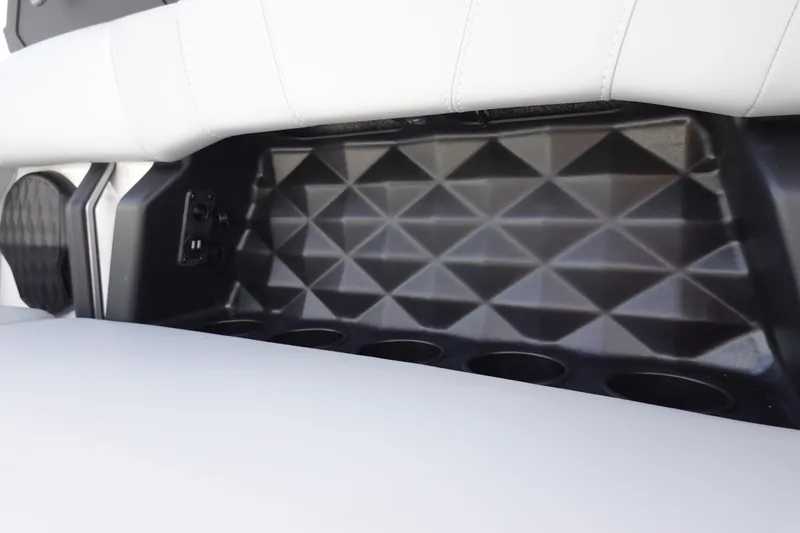 Slide: The Image of 2024 Malibu 21 LX-R interior detail with geometric design and cup holders. - 23