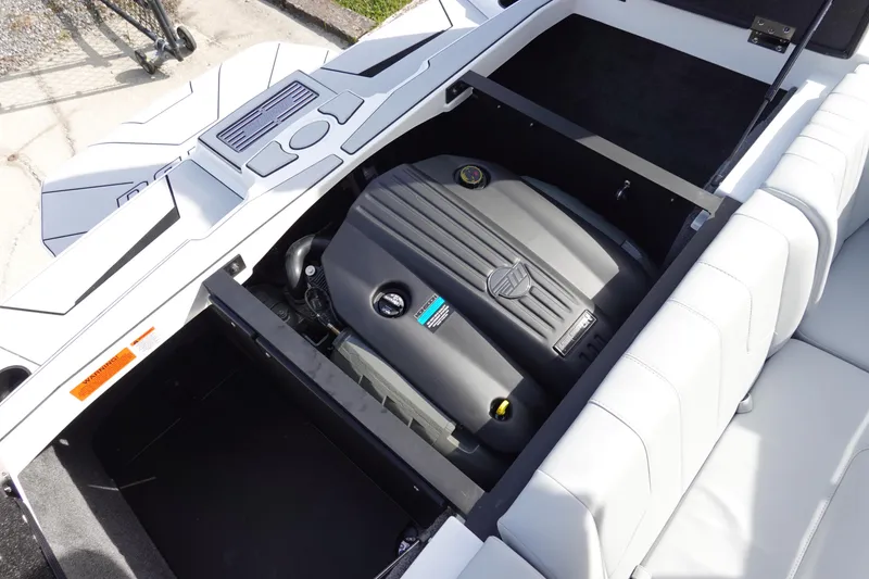 Slide: The Image of 2024 Malibu 21 LX-R boat engine compartment with open hatch. - 27