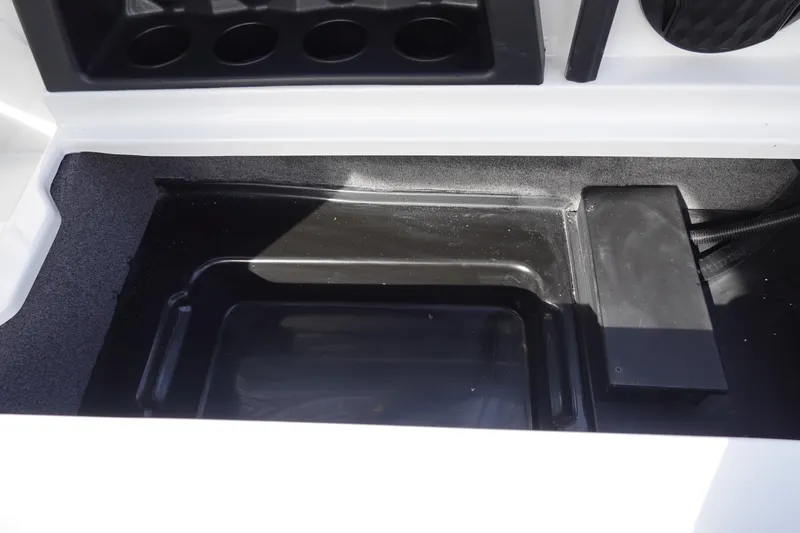 Slide: The Image of 2024 Malibu 21 LX-R boat storage compartment with cup holders. - 32