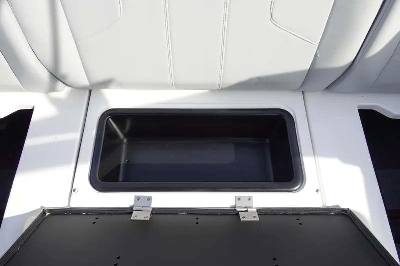 Slide: The Image of 2024 Malibu 21 LX-R boat storage compartment with open lid. - 33