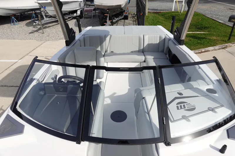 Slide: The Image of 2024 Malibu 21 LX-R boat interior with seating and windshield. - 36