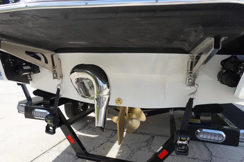 Slide: The Image of 2024 Malibu 21 LX-R boat stern with propeller and trailer. - 9