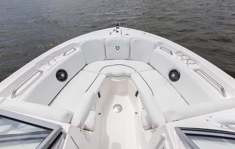 Slide: The Image of 2025 Sea Fox 228 Traveler boat interior with white seating and cup holders. - 10