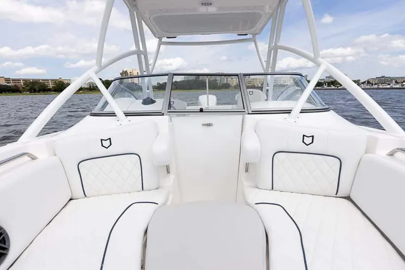 Slide: The Image of 2025 Sea Fox 228 Traveler boat interior with white cushioned seating and open water view. - 12