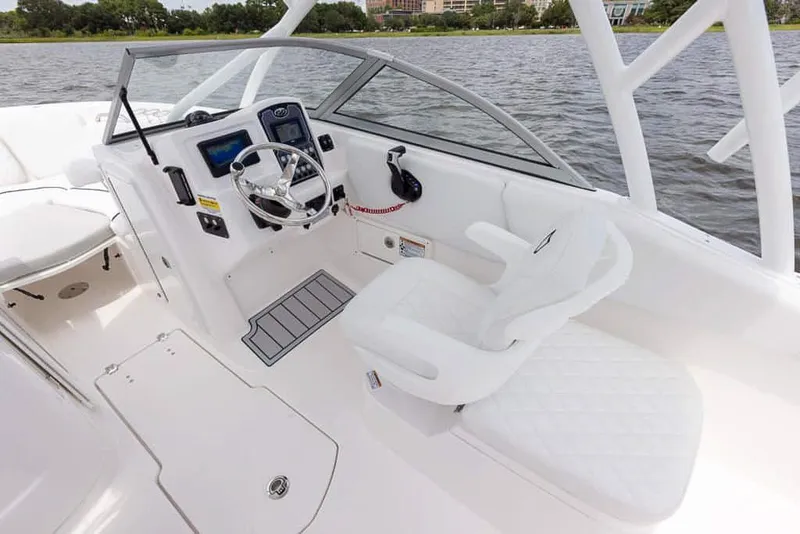 Slide: The Image of 2025 Sea Fox 228 Traveler boat interior with captain's seat and steering console. - 16