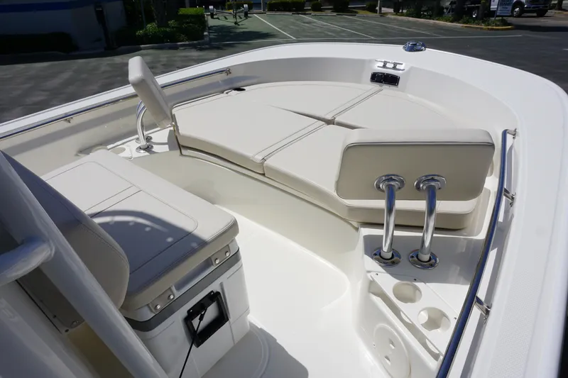 Slide: The Image of 2024 Boston Whaler 210 Montauk boat interior with cushioned seating and storage. - 10