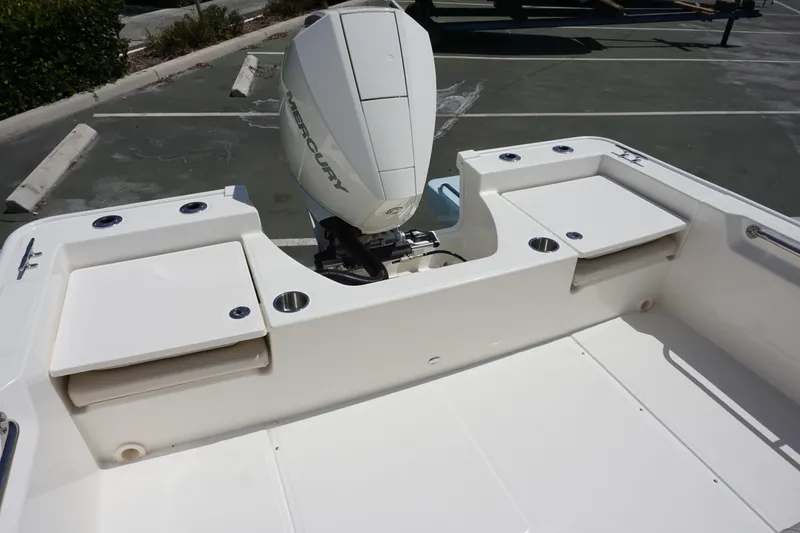 Slide: The Image of 2024 Boston Whaler 210 Montauk boat stern with Mercury outboard engine. - 14