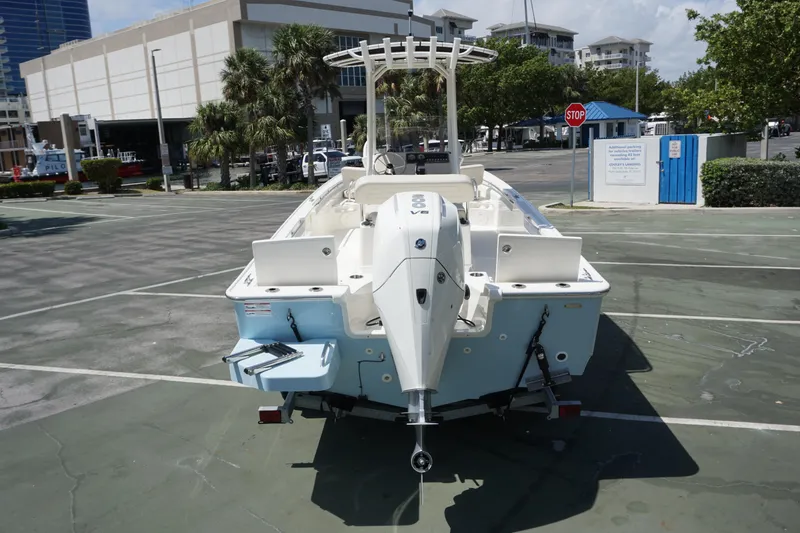 Slide: The Image of 2024 Boston Whaler 210 Montauk boat rear view in a parking lot. - 2