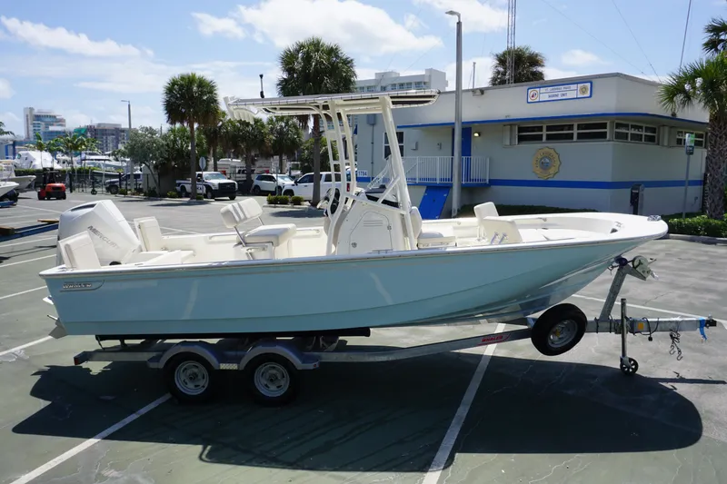 Slide: The Image of 2024 Boston Whaler 210 Montauk boat on a trailer in a parking lot. - 3