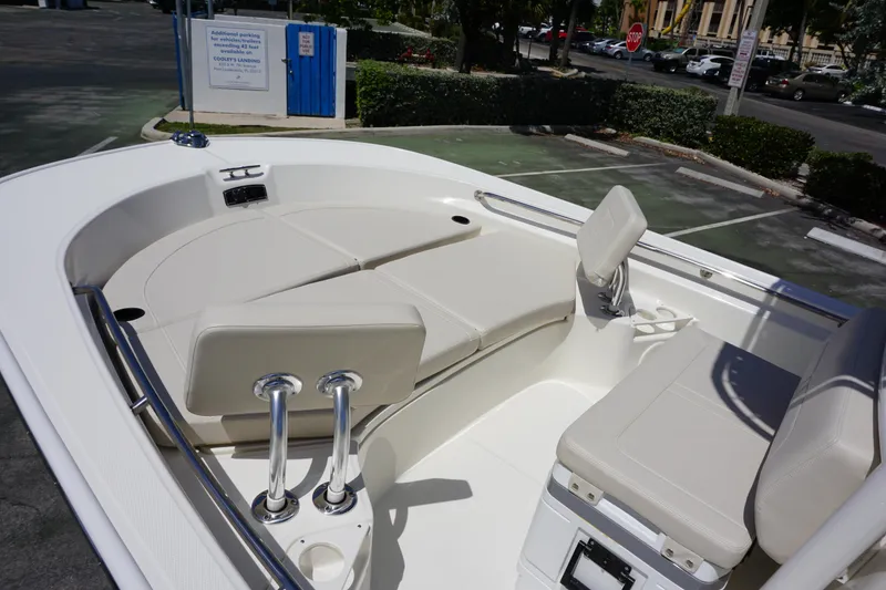 Slide: The Image of 2024 Boston Whaler 210 Montauk boat interior with cushioned seating and stainless steel fixtures. - 5