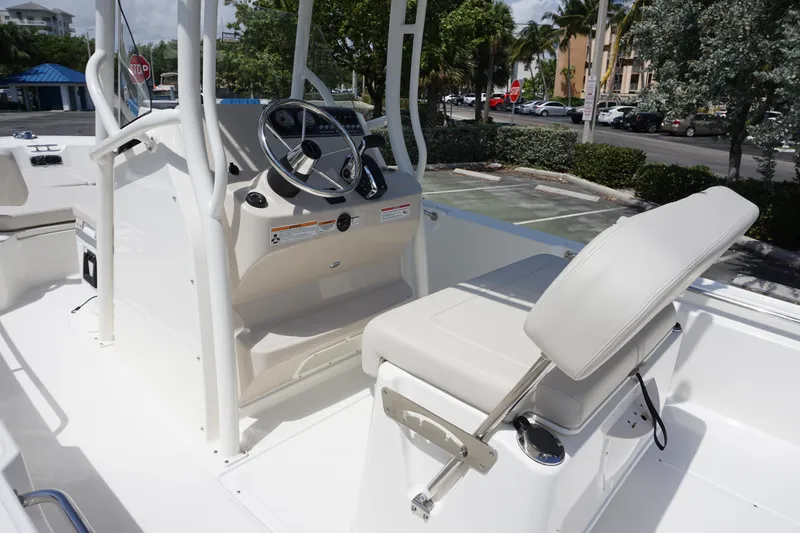 Slide: The Image of 2024 Boston Whaler 210 Montauk boat interior with steering console and seating. - 7