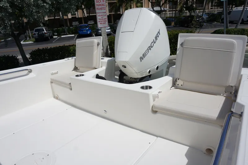 Slide: The Image of 2024 Boston Whaler 210 Montauk boat with Mercury engine and seating area. - 8