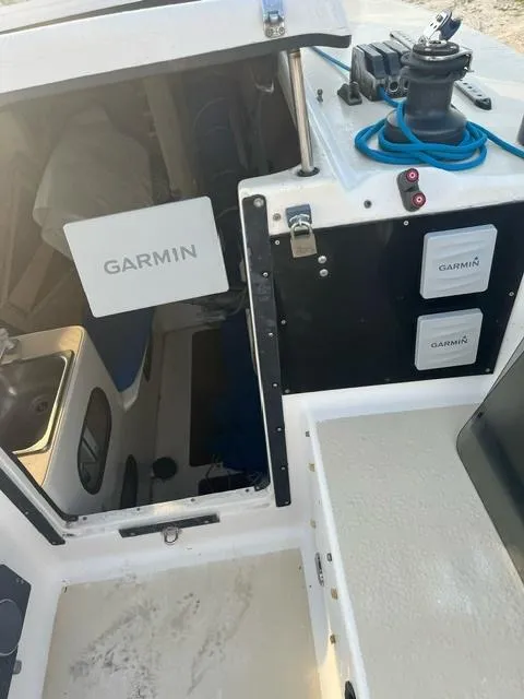 Slide: The Image of 1991 Corsair F27 boat cockpit with Garmin equipment and blue rope on deck. - 10