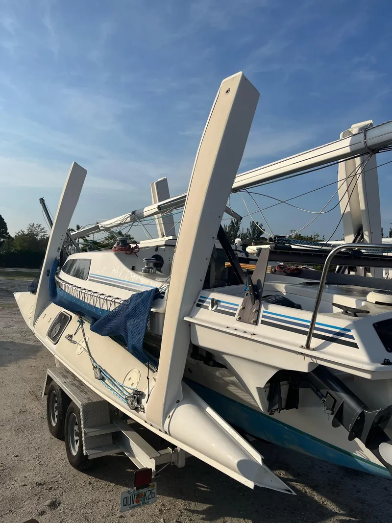 Slide: The Image of 1991 Corsair F27 sailboat on trailer under clear blue sky. - 12