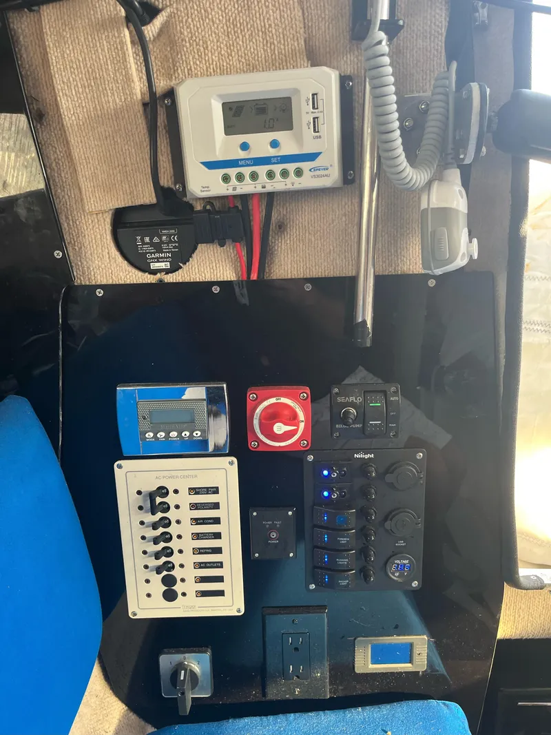 Slide: The Image of Control panel of a 1991 Corsair F27 boat with various switches and instruments. - 7