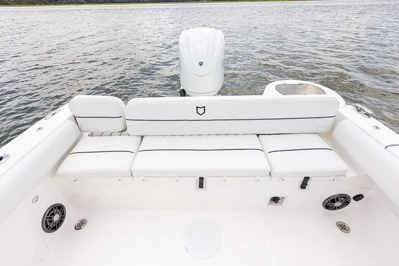 Slide: The Image of 2025 Sea Fox 248 Side Console boat with white cushioned seating and outboard motor. - 20