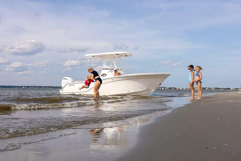 Slide: The Image of Family enjoying a day at the beach with a 2025 Sea Fox 248 Side Console boat. - 9