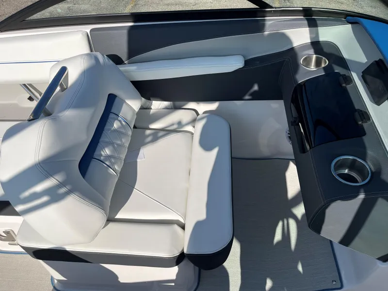 Slide: The Image of 2024 Regal LS2 boat interior with white seating and cup holders. - 10