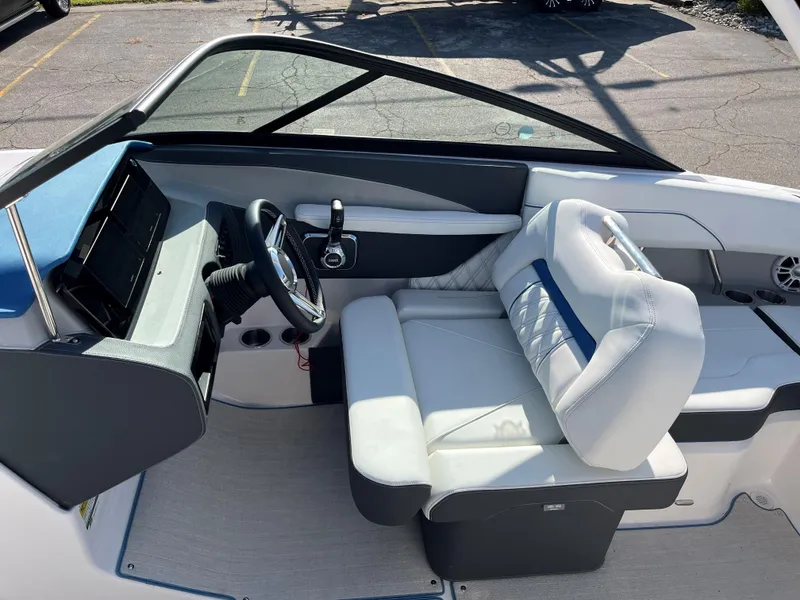 Slide: The Image of 2024 Regal LS2 boat interior with modern dashboard and comfortable seating. - 7