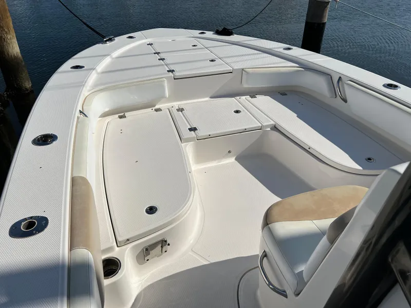 Slide: The Image of 2018 Robalo 246 Cayman boat on clear green water, aerial view. - 10