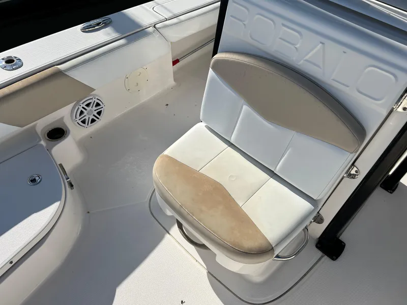 Slide: The Image of 2018 Robalo 246 Cayman boat cruising on open water, rear view. - 13