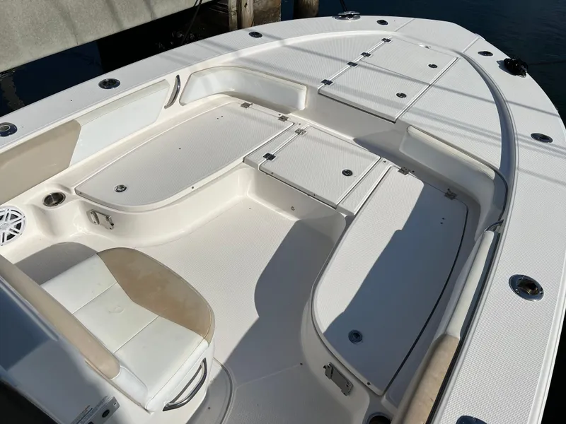 Slide: The Image of Storage compartment of 2018 Robalo 246 Cayman boat with orange case inside. - 16