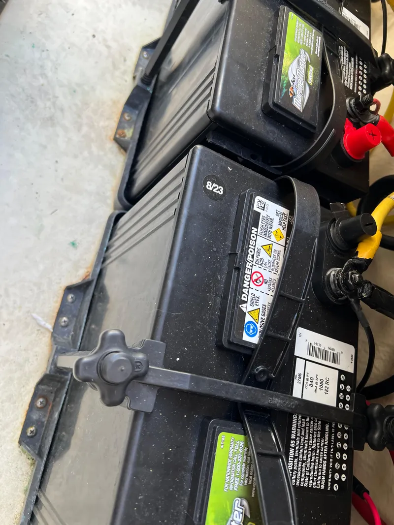 Slide: The Image of Batteries in a 2018 Robalo 246 Cayman boat, secured with straps. - 26