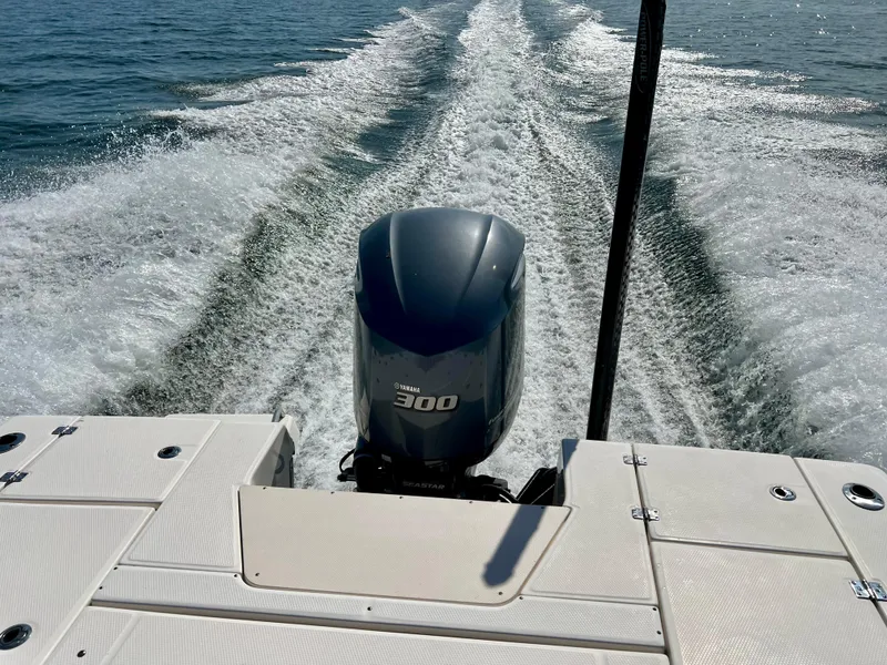 Slide: The Image of 2018 Robalo 246 Cayman boat interior with cushioned seating and storage compartments. - 8