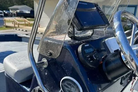 Slide: The Image of 2024 SeaArk RXT 180 boat console with steering wheel and navigation equipment. - 4