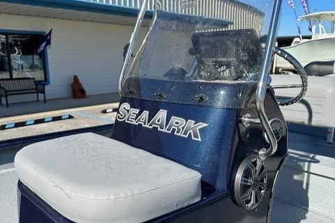 Slide: The Image of 2024 SeaArk RXT 180 boat console with cushioned seat and windshield. - 8
