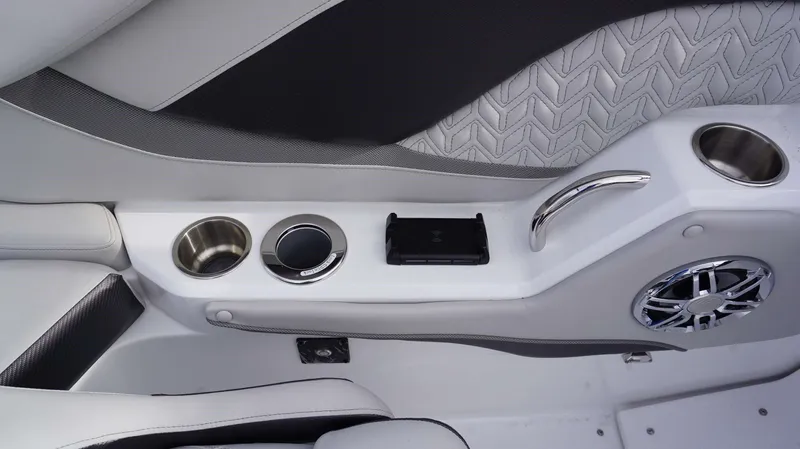 Slide: The Image of Interior of 2024 Hurricane 2600 SD boat with cup holders, speaker, and wireless charging pad. - 11
