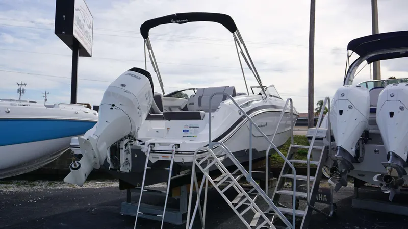 Slide: The Image of 2024 Hurricane 2600 SD boat on display with outboard motor. - 15