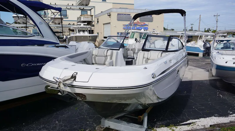 Slide: The Image of 2024 Hurricane 2600 SD boat displayed at a marina, featuring spacious seating and modern design. - 2