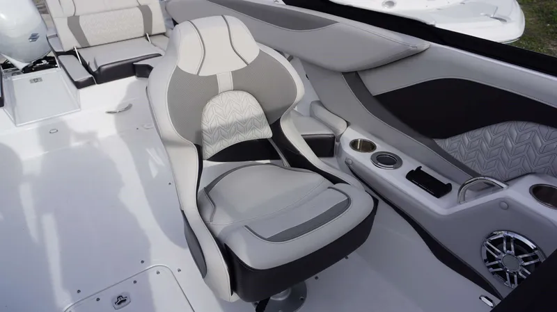 Slide: The Image of Luxury seating and console of 2024 Hurricane 2600 SD boat with cup holders and speaker. - 3