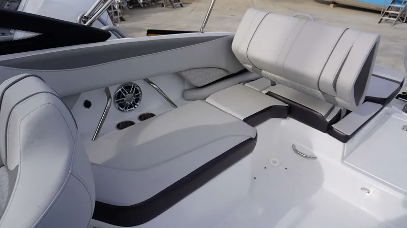 Slide: The Image of 2024 Hurricane 2600 SD boat interior with white and gray seating, cup holders, and speaker. - 5