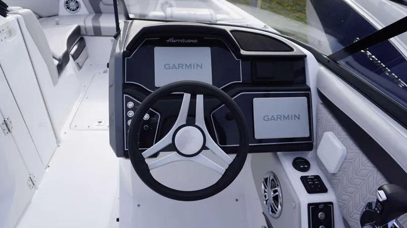 Slide: The Image of 2024 Hurricane 2600 SD boat dashboard with Garmin navigation system and steering wheel. - 7