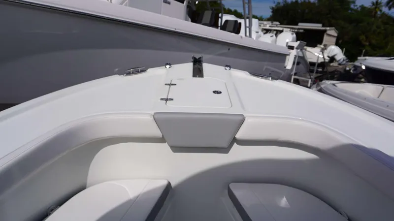 Slide: The Image of 2024 Parker 2200 CC boat bow seating area with storage compartment. - 11