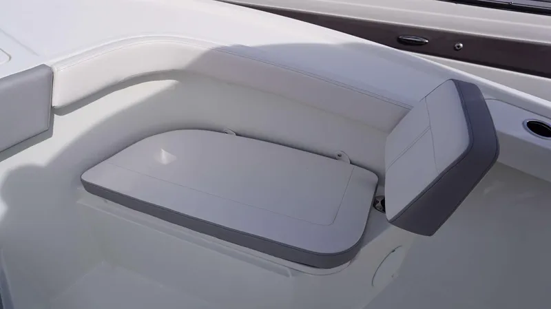 Slide: The Image of 2024 Parker 2200 CC boat interior seating with white and gray cushions. - 13