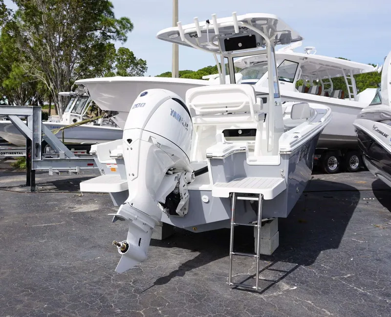 Slide: The Image of 2024 Parker 2200 CC boat with Yamaha outboard motor, docked on a trailer. - 6