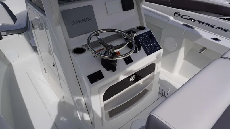 Slide: The Image of 2024 Parker 2200 CC boat console with Garmin navigation system and steering wheel. - 8