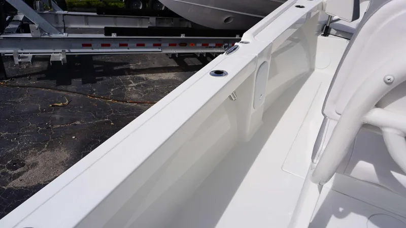 Slide: The Image of 2024 Parker 2200 CC boat interior, white seating and rod holders. - 9